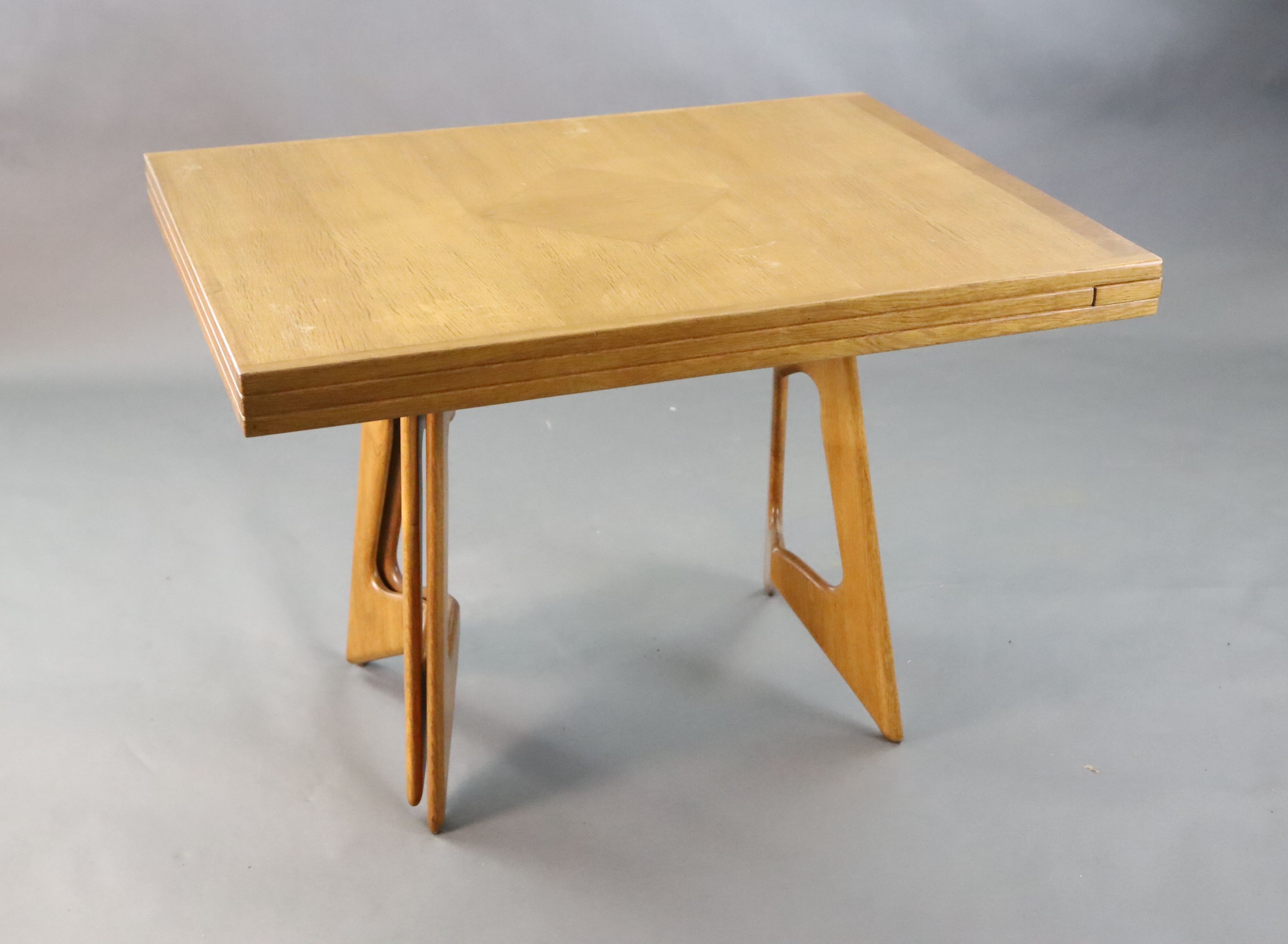 A Guillerme & Chambron golden oak draw leaf dining table, W.3ft 7in. D.2ft 9in. when closed, H.2ft 5in.